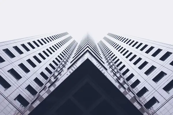 View between two identical high-rise buildings, emphasizing security guard presence in condominiums and high-rise properties