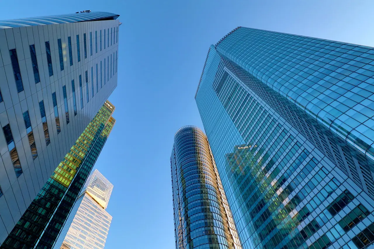 View looking up at towering skyscrapers with reflective glass facades, highlighting the need for condominium high rise security