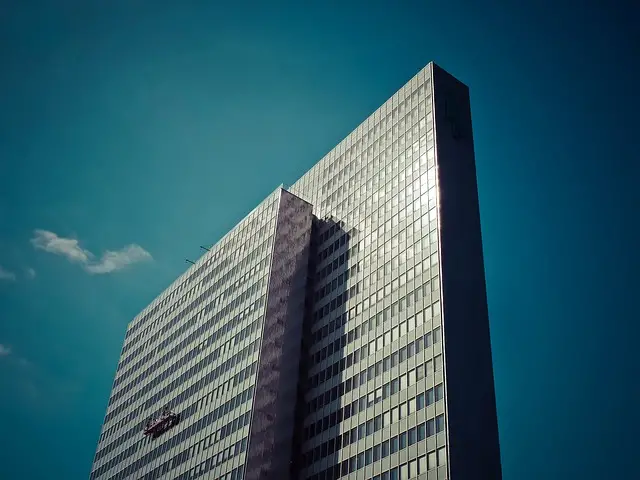 Tall condominium with reflective windows and angular design, highlighting the need for condominium high rise security guard