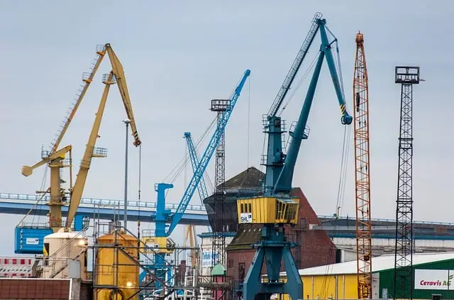 New York City Guard - Busy industrial port with cranes and warehouses, highlighting industrial security services