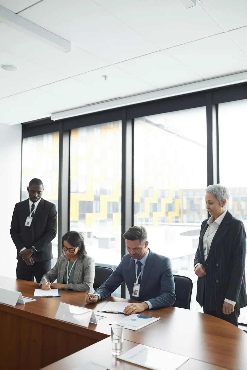 Group in formal attire in conference room, highlighting the need for private security guard services