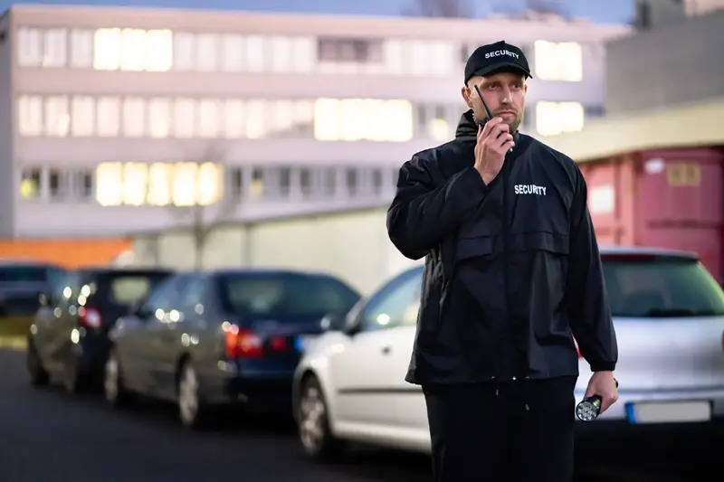 New York City Guard - Security guard in black uniform with walkie-talkie in parking lot, professional security services