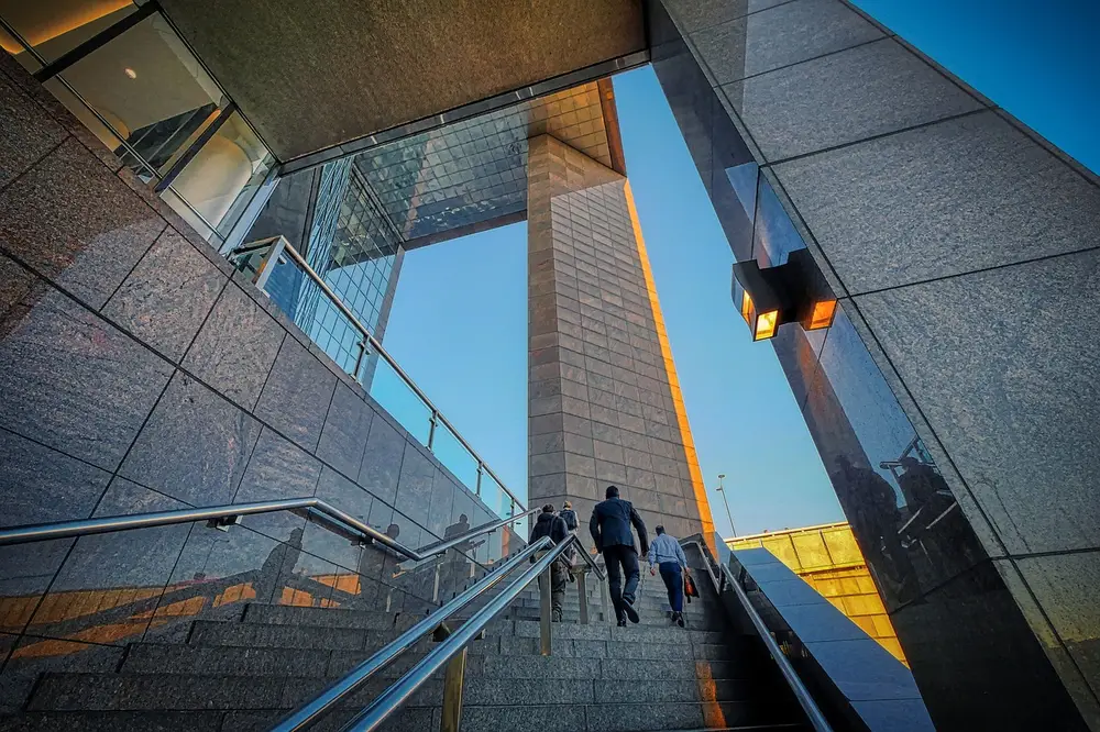 Modern architectural structure with geometric design and stairs, emphasizing the need for high tech security guard services